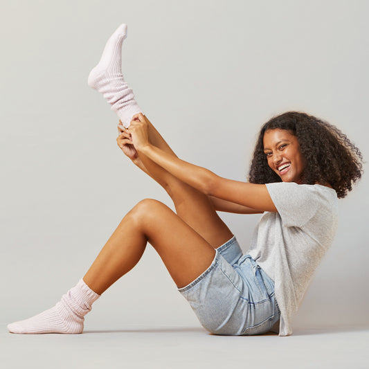 Woman pulling up pink slouch socks
