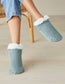 Woman wearing Simon de Winter Women's Chunky Knit Home Socks in Mineral Blue